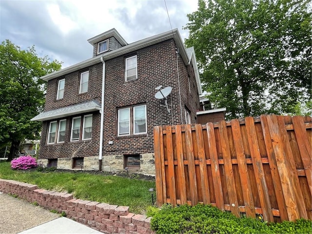 129 S Braddock Ave, Point Breeze, PA 15221 - view of property exterior featuring brick siding and fence