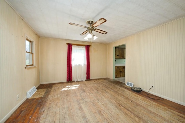 829 Fellsburg Rd, Rostraver, PA 15012 - unfurnished room featuring ceiling fan, a healthy amount of sunlight, hardwood / wood-style floors, and visible vents