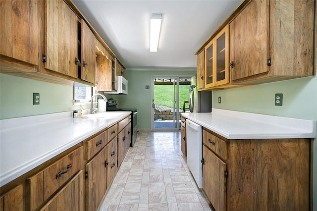 829 Fellsburg Rd, Rostraver, PA 15012 - kitchen featuring a sink, glass insert cabinets, white appliances, brown cabinetry, and light countertops