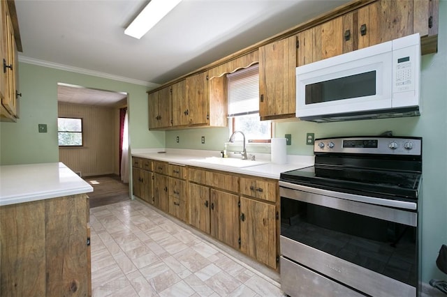 829 Fellsburg Rd, Rostraver, PA 15012 - kitchen with a sink, stainless steel electric range, white microwave, crown molding, and light countertops