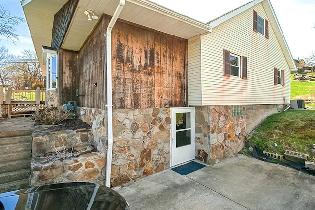 829 Fellsburg Rd, Rostraver, PA 15012 - exterior space with a wooden deck, a patio area, stone siding, and central AC unit