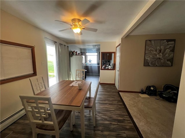 dining space featuring dark wood finished floors, a baseboard radiator, baseboards, and ceiling fan