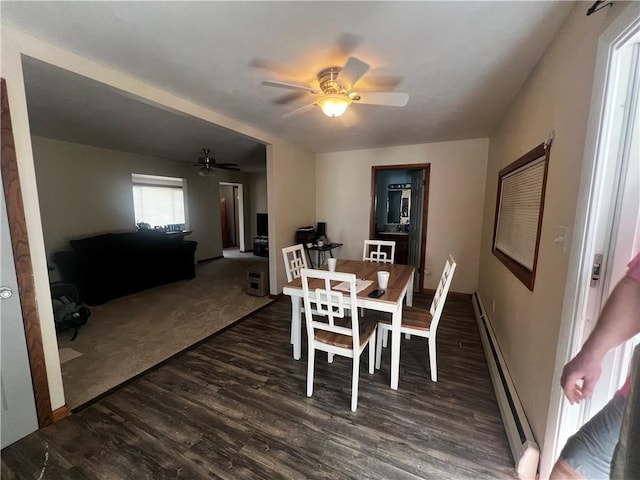 dining room featuring a baseboard radiator, baseboards, a ceiling fan, and dark wood-style floors