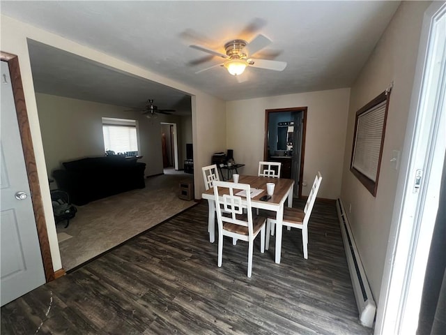 dining space featuring dark wood-type flooring, baseboards, a ceiling fan, and baseboard heating