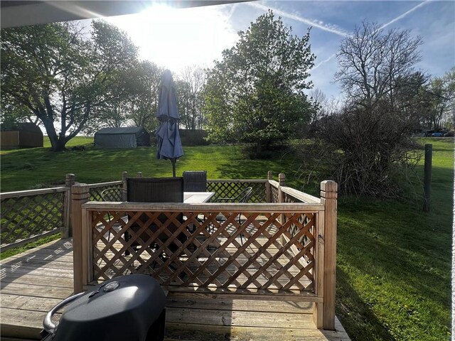 wooden deck with a lawn