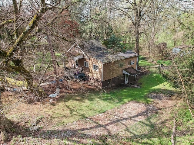 view of side of property with roof with shingles