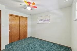 unfurnished bedroom with a closet, carpet flooring, and ceiling fan