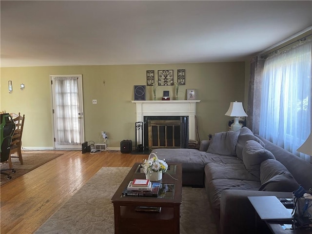 4710 Doverdell Dr, Whitehall, PA 15236 - living area with baseboards, a glass covered fireplace, and wood finished floors