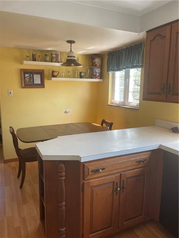 4710 Doverdell Dr, Whitehall, PA 15236 - kitchen featuring a peninsula, wood finished floors, and light countertops