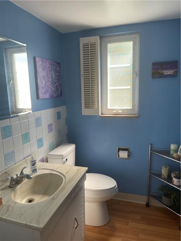 4710 Doverdell Dr, Whitehall, PA 15236 - bathroom with wood finished floors, toilet, and vanity