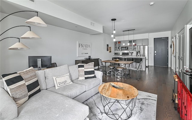 living area with visible vents and dark wood-style flooring