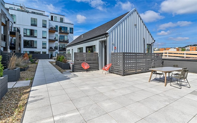 surrounding community with fence and a patio