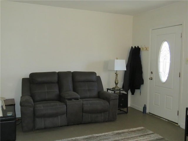 living area featuring baseboards