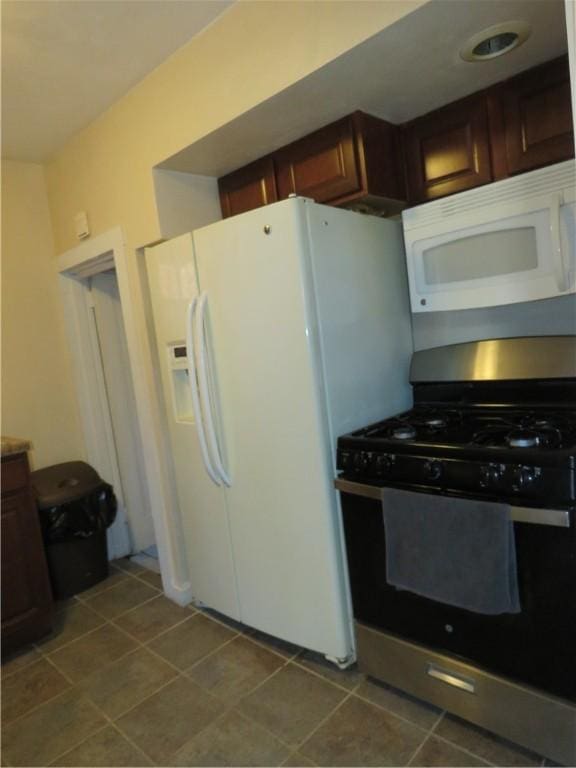 kitchen with tile patterned flooring and white appliances