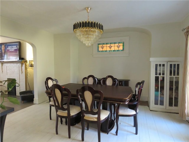 dining room featuring arched walkways and a chandelier