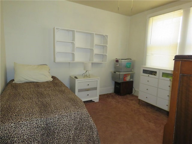 bedroom with dark colored carpet