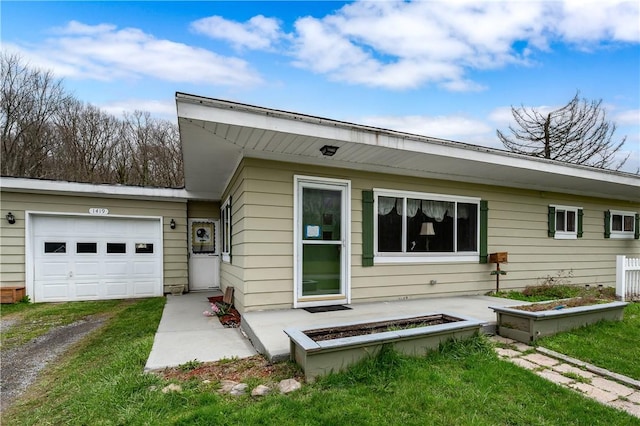 exterior space with a garage, driveway, and a lawn
