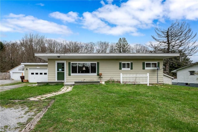 view of front of home featuring an attached garage, driveway, and a front lawn