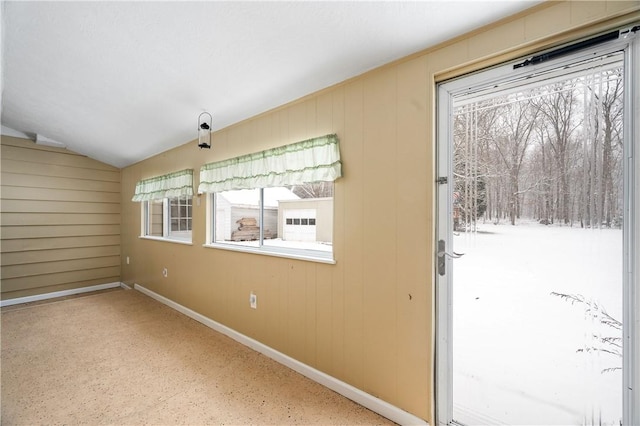 interior space with lofted ceiling and baseboards