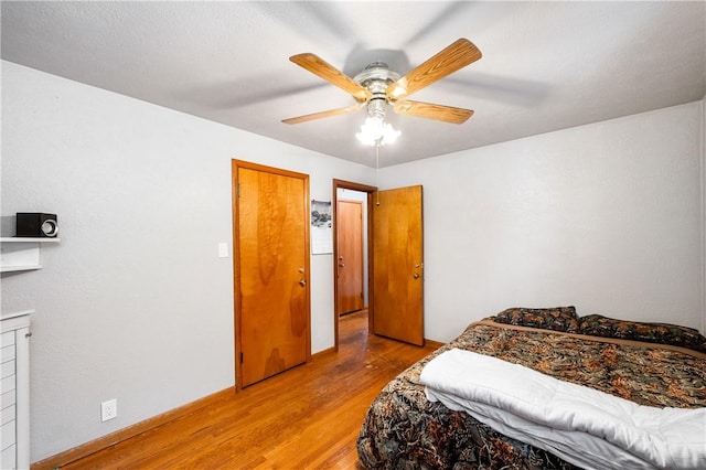 bedroom with light wood-style floors and a ceiling fan