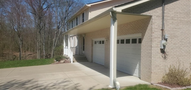 view of home's exterior featuring an attached garage and brick siding
