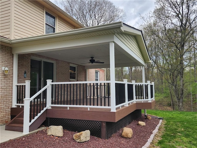 wooden terrace with covered porch and a ceiling fan