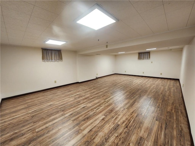 finished below grade area with wood finished floors and baseboards