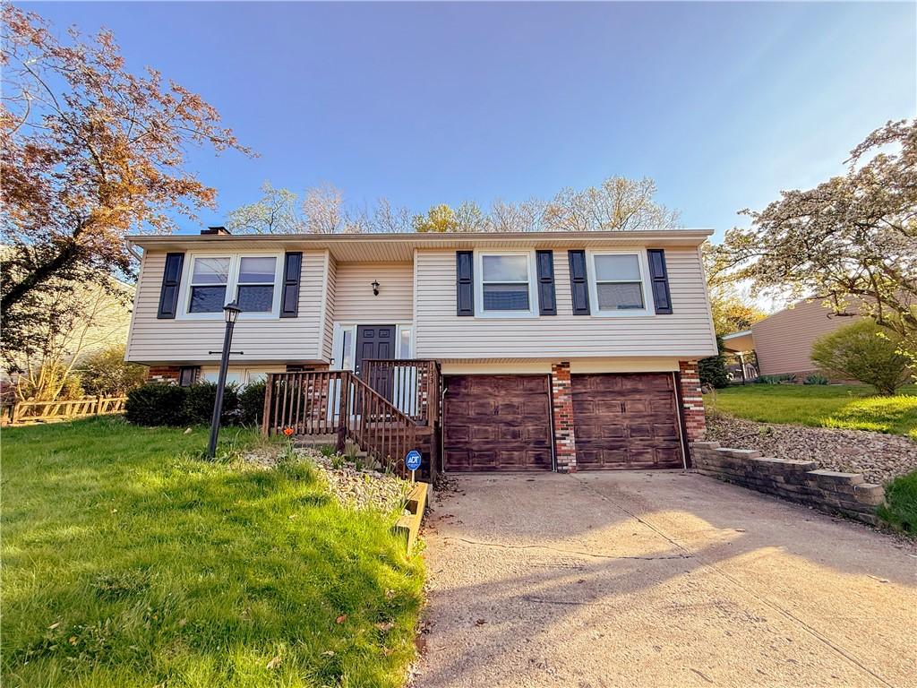 133 Glengarry Dr, Moon/Crescent Twp, PA 15108 - split foyer home featuring a front lawn, concrete driveway, brick siding, and an attached garage