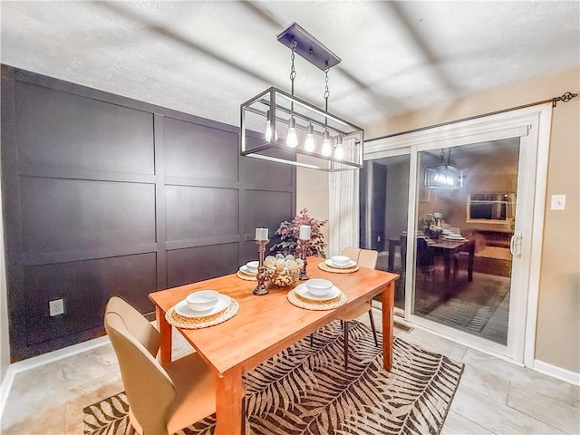 dining area with baseboards and light tile patterned flooring