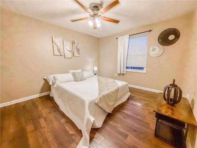bedroom featuring a ceiling fan, wood finished floors, and baseboards