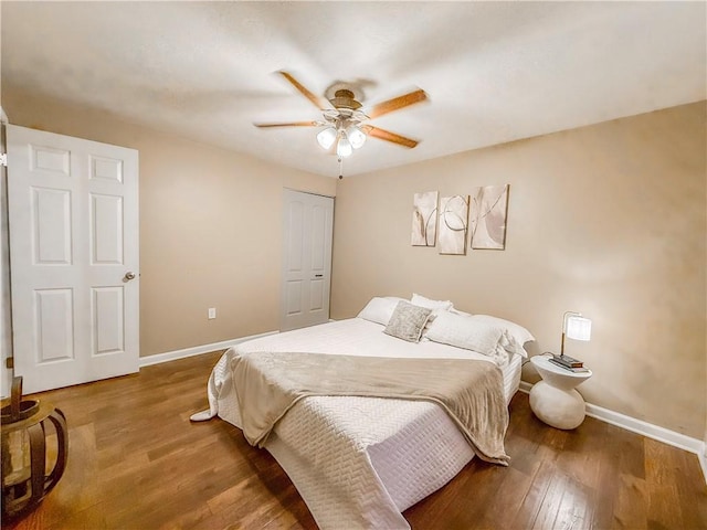 bedroom featuring wood finished floors, a ceiling fan, and baseboards