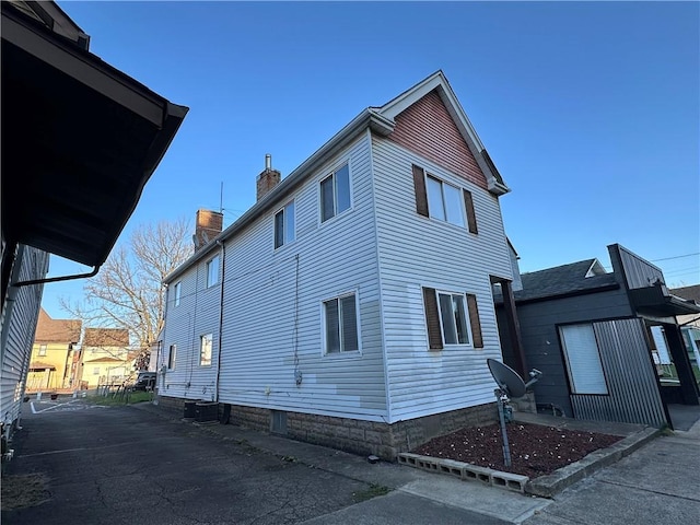 view of side of home with a chimney