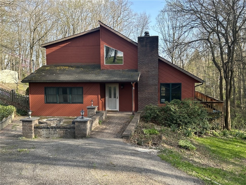 view of front of home featuring fence and a chimney