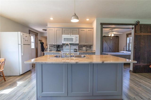 2939 Perry Hwy, Perry Twp Mer, PA 16130 - kitchen with tasteful backsplash, a sink, light wood-style floors, recessed lighting, and white appliances