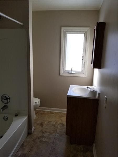 full bathroom with toilet, shower / bath combination, vanity, and baseboards