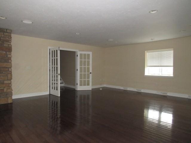 unfurnished room featuring french doors, recessed lighting, dark wood-style floors, and baseboards