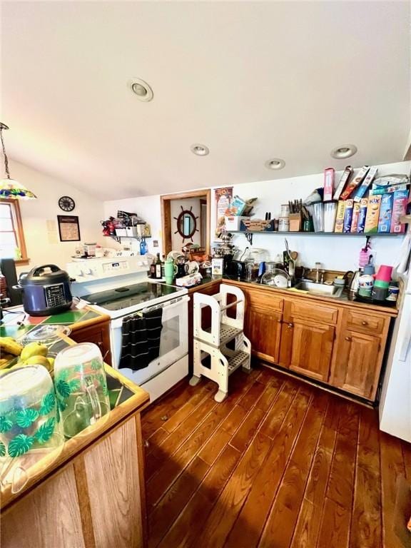 kitchen with dark wood finished floors, electric range, lofted ceiling, and a sink