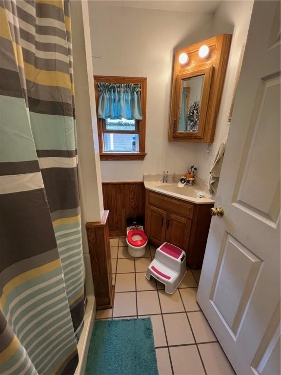 bathroom with vanity, a shower with curtain, and tile patterned flooring