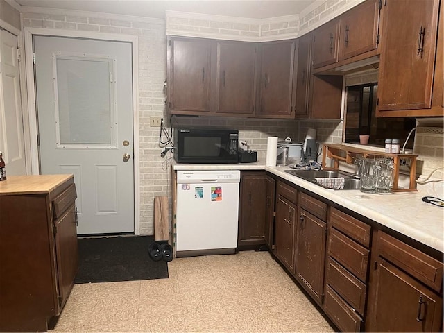 kitchen featuring decorative backsplash, black microwave, dishwasher, light countertops, and light floors