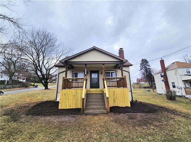 view of front of house featuring covered porch and a chimney