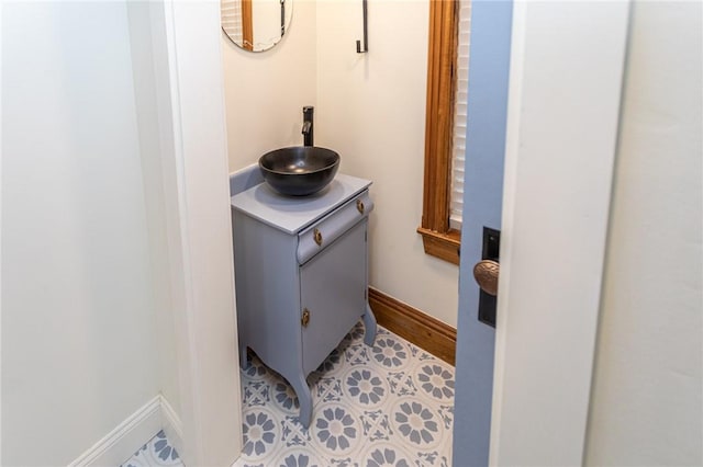 details featuring vanity and baseboards