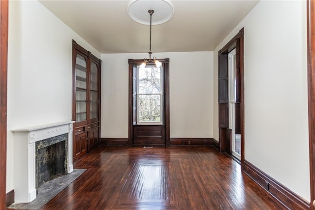interior space with hardwood / wood-style floors, baseboards, and a fireplace