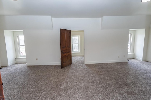 empty room with baseboards, carpet floors, and plenty of natural light