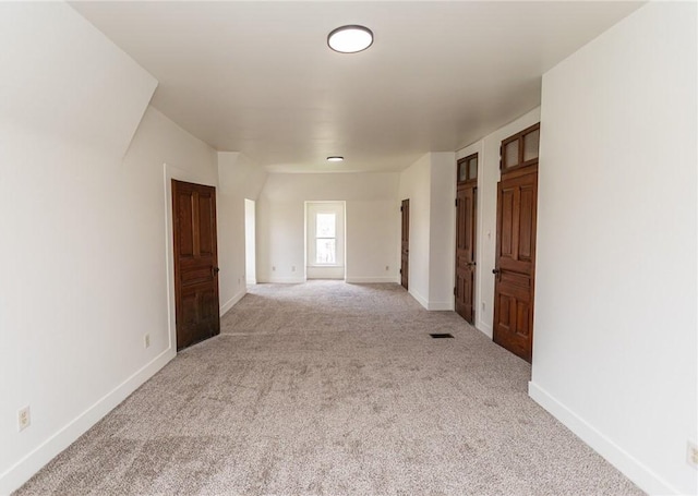 unfurnished room featuring carpet flooring and baseboards