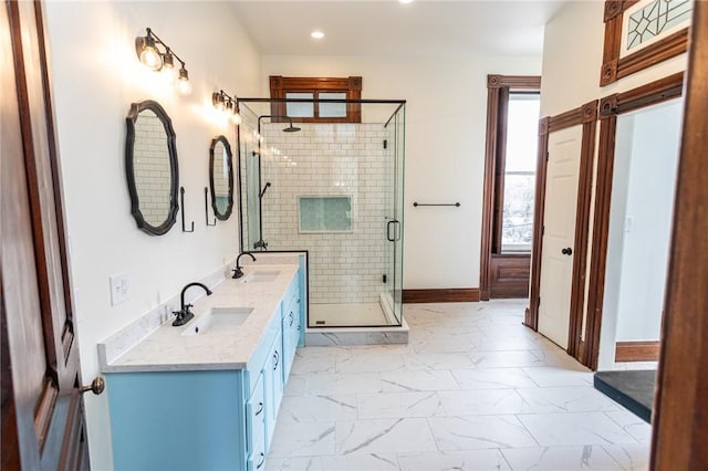 bathroom with recessed lighting, marble finish floor, a sink, and a shower stall