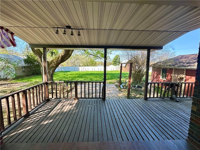 wooden terrace with fence and a yard