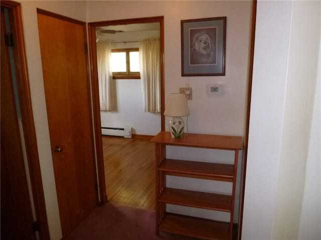 corridor featuring a baseboard heating unit