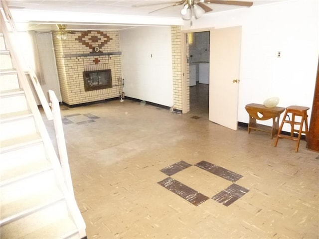 living room with ceiling fan and a fireplace