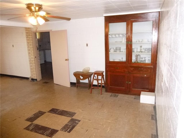 entryway featuring light floors and a ceiling fan