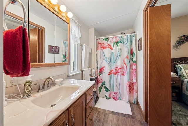 full bathroom featuring vanity, ensuite bathroom, vaulted ceiling, wood finished floors, and a shower with shower curtain